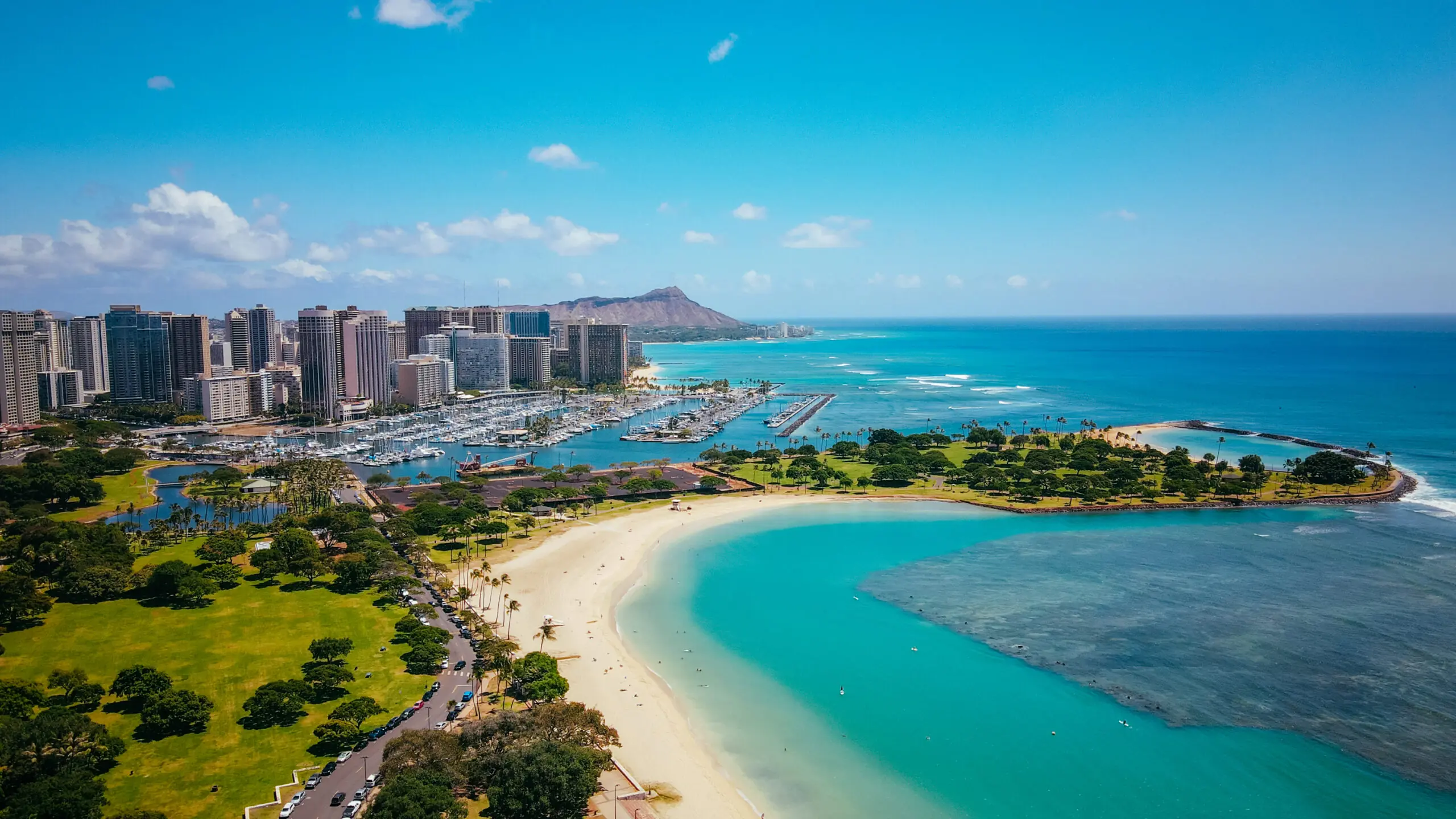 Aerial view of Ala Moana Beach Park with turquoise water and city skyline