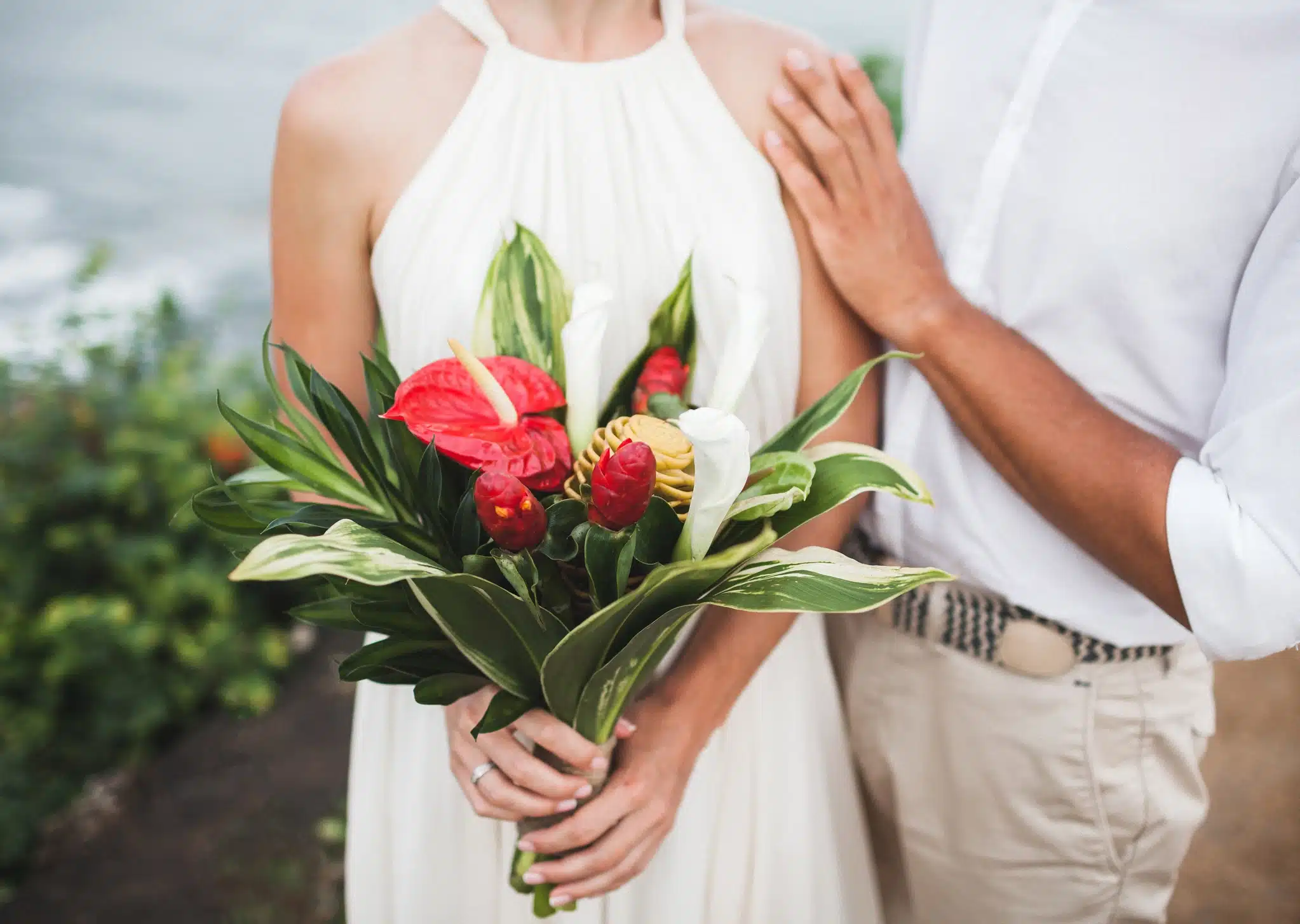 Couple holding a tropical bridal bouquet at a Pagoda Hotel Honolulu wedding